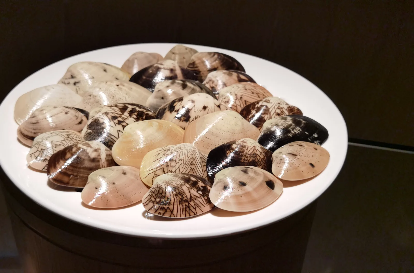 A chilled seafood platter on ice: lobster, oysters topped with caviar, scallops and sashimi.